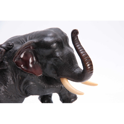 248 - A JAPANESE MEIJI PERIOD PATINATED BRONZE SCULPTURE modelled as an elephant being attacked by two tig... 