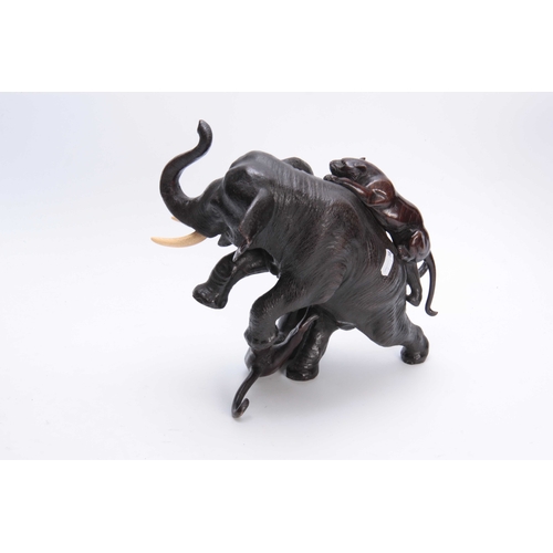 248 - A JAPANESE MEIJI PERIOD PATINATED BRONZE SCULPTURE modelled as an elephant being attacked by two tig... 