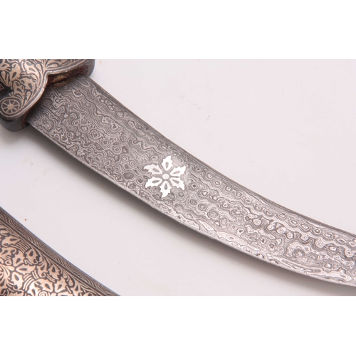 260 - A 19TH CENTURY INDIAN JAMBARI DAGGER of curved form with dogs head terminal to the handle, engraved ... 