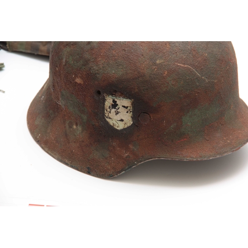 283 - TWO SECOND WORLD WAR ARMY HELMETS,  the camouflage example American, the other German