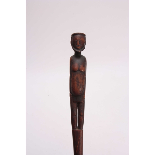 285 - AN AFRICAN CARVED HARDWOOD WALKING CANE the handle modeled as a standing figure 91cm overall