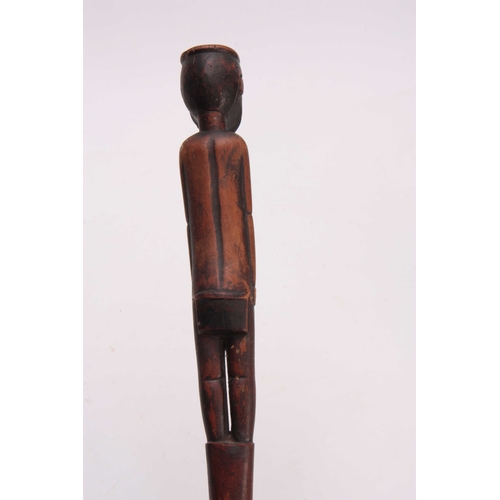 285 - AN AFRICAN CARVED HARDWOOD WALKING CANE the handle modeled as a standing figure 91cm overall