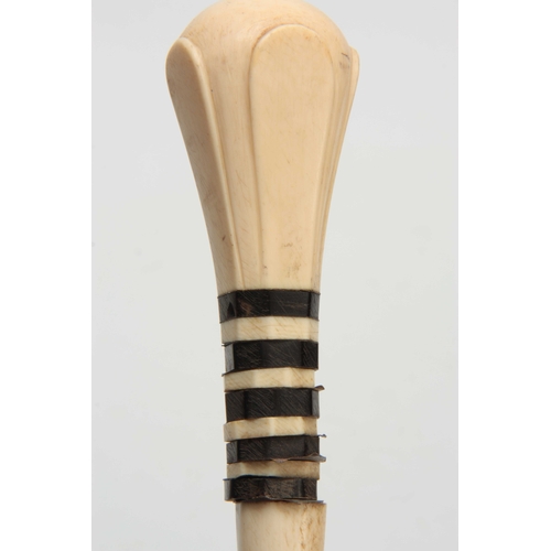 296 - A 19th CENTURY IVORY AND BALEEN BANDED WALKING CANE of segmented form with a carved handle on a simu... 