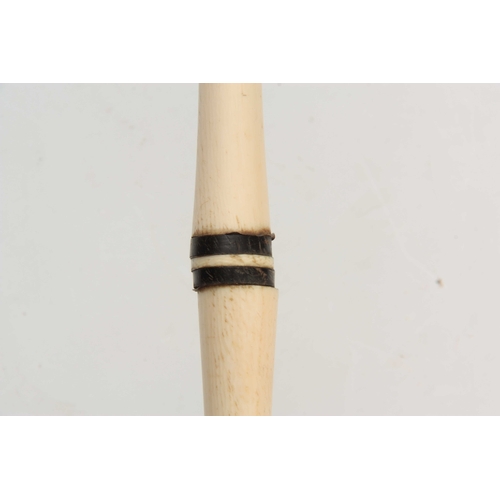 296 - A 19th CENTURY IVORY AND BALEEN BANDED WALKING CANE of segmented form with a carved handle on a simu... 