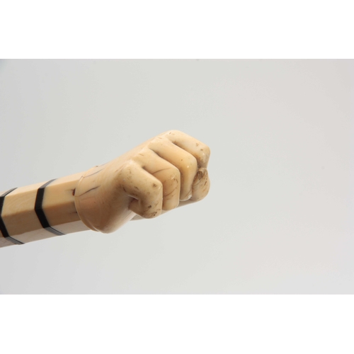 298 - A 19th CENTURY WHALEBONE AND MARINE IVORY WALKING CANE having a carved fist handle on a chamfered bo... 