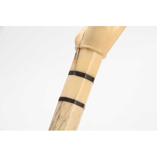 298 - A 19th CENTURY WHALEBONE AND MARINE IVORY WALKING CANE having a carved fist handle on a chamfered bo... 