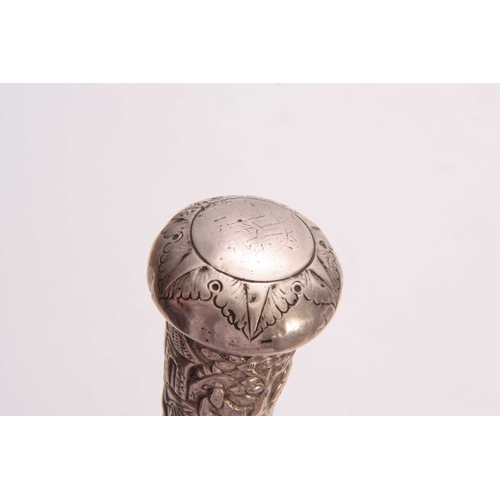 299 - A LATE 19th CENTURY ORIENTAL SILVER HANDLED MALACCA WALKING CANE the handle embossed with figures in... 