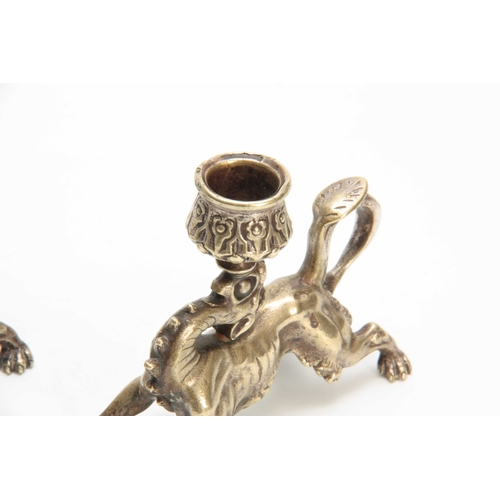 334 - A PAIR OF 19TH CENTURY CONTINENTAL NICKEL PLATED STYLISED GRIFFIN CANDLESTICKS with raised flower he... 