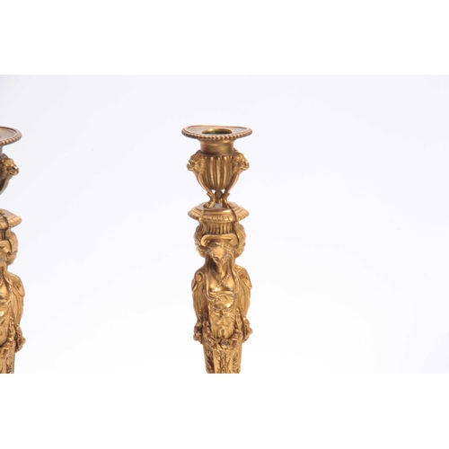 337 - A PAIR OF 19TH CENTURY FRENCH ROCOCO BRONZE AND ORMOLU FIGURAL CANDLESTICKS with lions head urn-shap... 