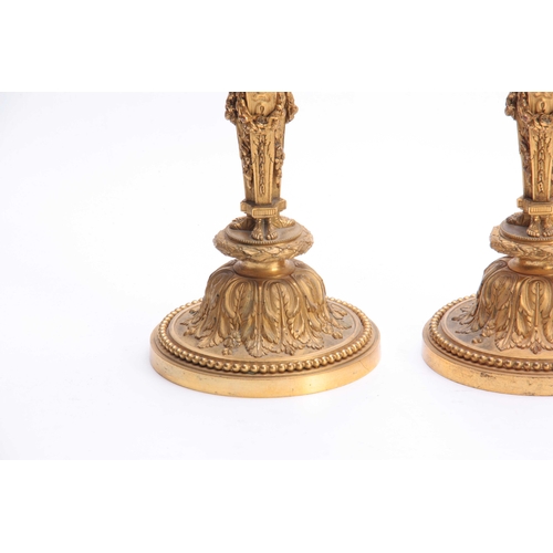 337 - A PAIR OF 19TH CENTURY FRENCH ROCOCO BRONZE AND ORMOLU FIGURAL CANDLESTICKS with lions head urn-shap... 