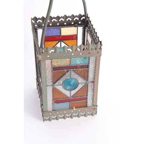 350 - A LATE VICTORIAN GOTHIC STYLE STAINED GLASS  BRASS HALL LANTERN with coloured panels and shaped hang... 