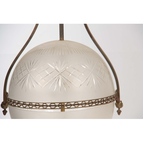 353 - A STYLISH 20TH CENTURY ORBITAL GLOBE SHAPED LIGHT FITTING with cut glass shade and shaped brass fram... 