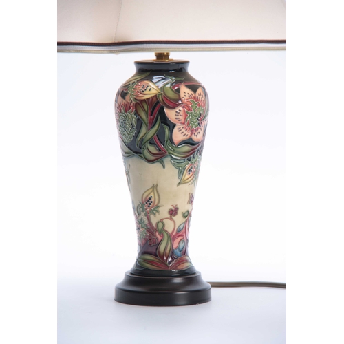 44 - A MODERN MOORCROFT TABLE LAMP with colourful tube lined flower decoration 47cn high to top of the sh... 