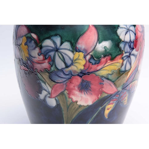 61 - A LARGE 20TH CENTURY MOORCROFT BULBOUS VASE decorated with Orchids - signed underneath W. Moorcroft ... 