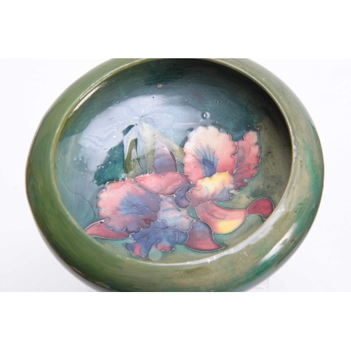 64 - AN EARLY 20th CENTURY MOORCROFT PLATE with pomegranate design, signed and impressed marks to the und... 