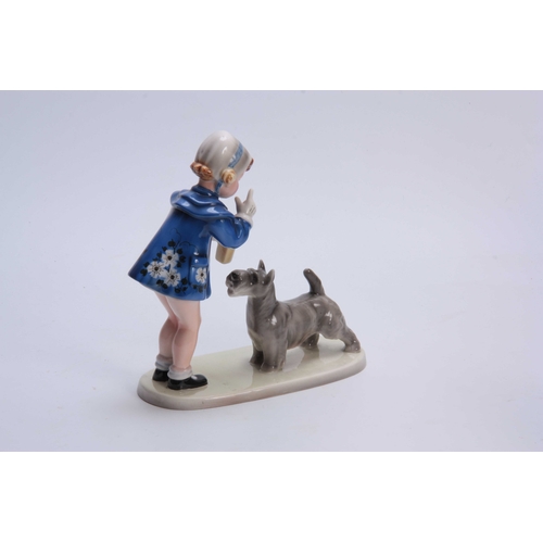 76 - A GOLDSCHEIDER AUSTRIAN FIGURE GROUP depicting a standing boy wearing a blue coat with a dog 23cm hi... 