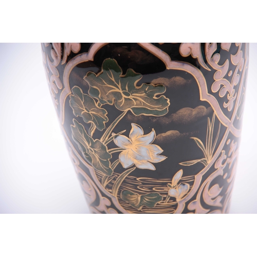 79 - A 20TH CENTURY PERSIAN DESIGNED CERAMIC VASE decorated with Pony Lilies, highlighted in gilt 26cm hi... 