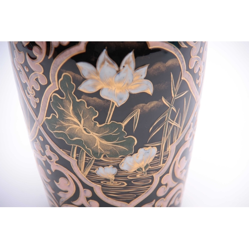 79 - A 20TH CENTURY PERSIAN DESIGNED CERAMIC VASE decorated with Pony Lilies, highlighted in gilt 26cm hi... 