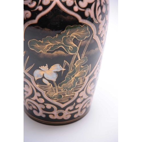 79 - A 20TH CENTURY PERSIAN DESIGNED CERAMIC VASE decorated with Pony Lilies, highlighted in gilt 26cm hi... 