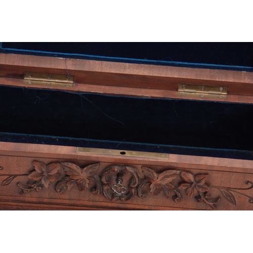 363 - A LATE 19TH/EARLY 20TH CENTURY SWISS CARVED BLACK FOREST JEWELLERY CASKET the lid with a pair of hig... 