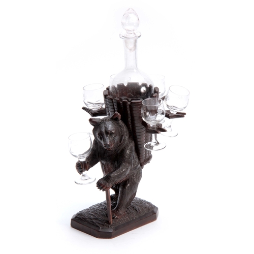 365 - A LATE 19TH CENTURY SWISS CARVED BLACK FOREST BEAR DECANTER SET modelled as a bear carrying a basket... 