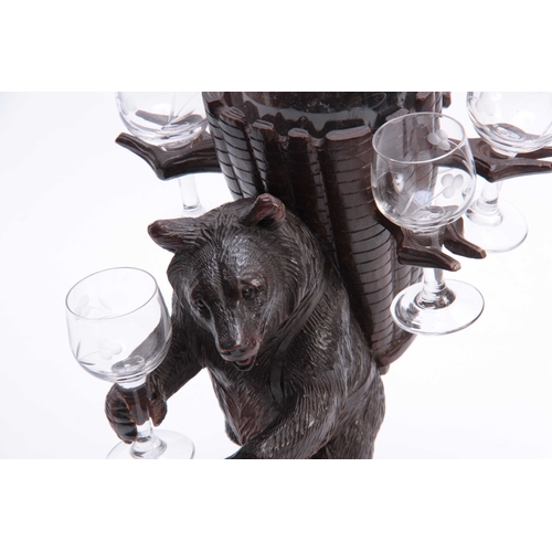 365 - A LATE 19TH CENTURY SWISS CARVED BLACK FOREST BEAR DECANTER SET modelled as a bear carrying a basket... 