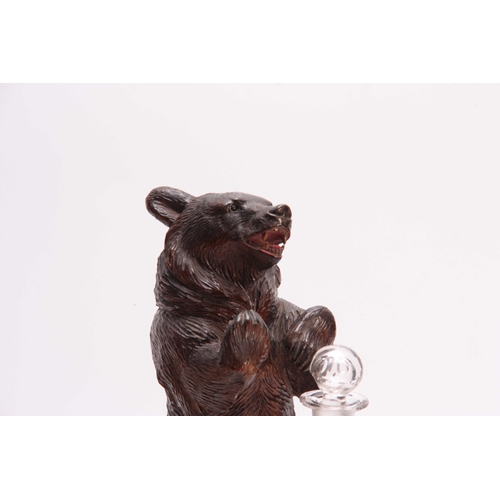 370 - AN EARLY 20th CENTURY CARVED BLACK FOREST MUSICAL DECANTER STAND modelled as a standing bear beside ... 