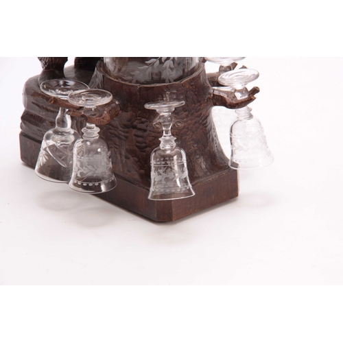 370 - AN EARLY 20th CENTURY CARVED BLACK FOREST MUSICAL DECANTER STAND modelled as a standing bear beside ... 