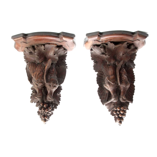 371 - A LARGE PAIR OF CARVED OAK BLACK FOREST WALL BRACKETS one having a lifesize brace of partridge among... 