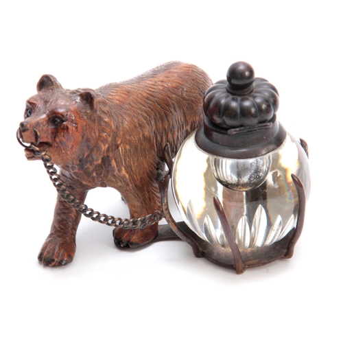 372 - A 19TH CENTURY SWISS CARVED BLACK FOREST BEAR INKWELL depicting a walking bear attached to a cut gla... 