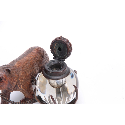 372 - A 19TH CENTURY SWISS CARVED BLACK FOREST BEAR INKWELL depicting a walking bear attached to a cut gla... 