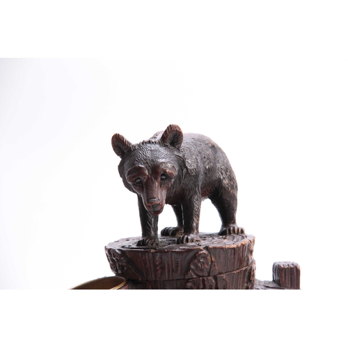 378 - A LATE 19TH CENTURY SWISS CARVED BEAR TOBACCO BOX with hinged compartment and brass match holder dep... 