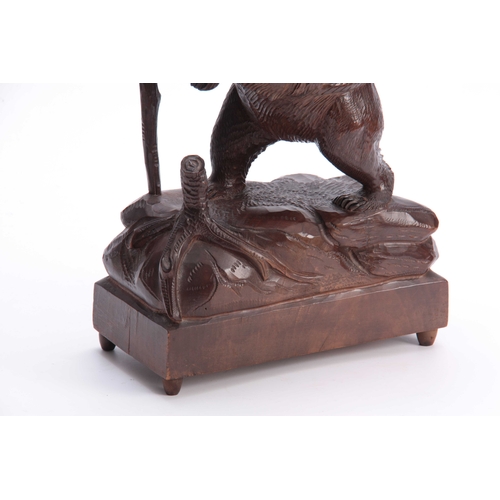 379 - A LATE 19TH CENTURY SWISS CARVED BLACK FOREST BEAR MUSICAL DECANTER SET modelled as a bear carrying ... 