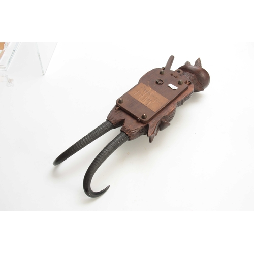 380 - A LARGE LATE 19th CENTURY MUSICAL CARVED BLACK FOREST COAT HOOK modelled as a well-dressed fox with ... 