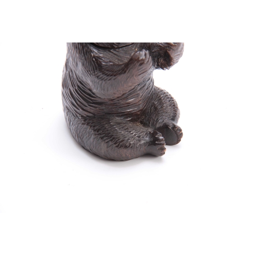 381 - A 19TH CENTURY SWISS CARVED BLACK FOREST SEATED BEAR INKWELL with hinged lid and arms outstretched f... 