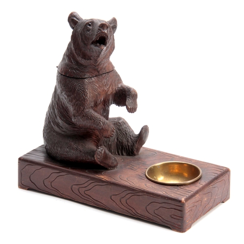 382 - A LATE 19TH CENTURY SWISS CARVED BEAR MUSICAL CIGAR BOX with hinged compartment and brass match hold... 