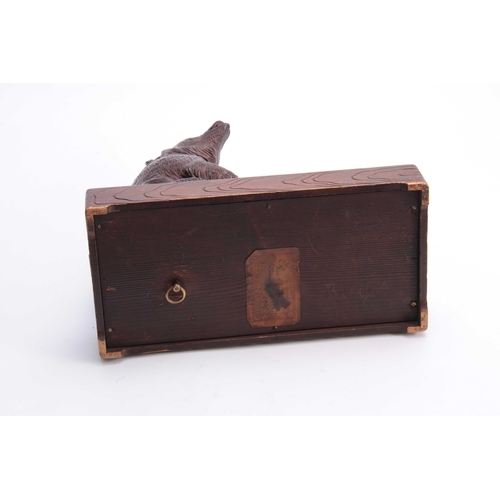 382 - A LATE 19TH CENTURY SWISS CARVED BEAR MUSICAL CIGAR BOX with hinged compartment and brass match hold... 