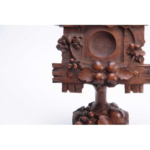 383 - A 19TH CENTURY SWISS CARVED BLACK FOREST POCKET WATCH HOLDER decorated with a cross-hatched frame wi... 