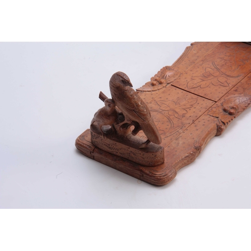 385 - A LATE 19TH CENTURY SWISS BLACK FOREST CARVED ADJUSTABLE BOOKREST with partridge to each side on nat... 