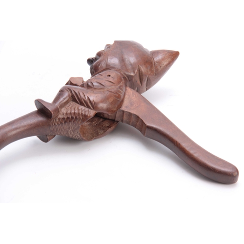 387 - A LATE 19TH CENTURY SWISS BLACK FOREST NUTCRACKER formed as a gnome 25cm overall.