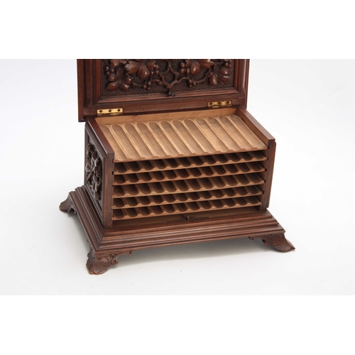 390 - A LATE 19TH CENTURY SWISS WALNUT CIGAR CABINET with carved fruiting leaf work panels to the front an... 