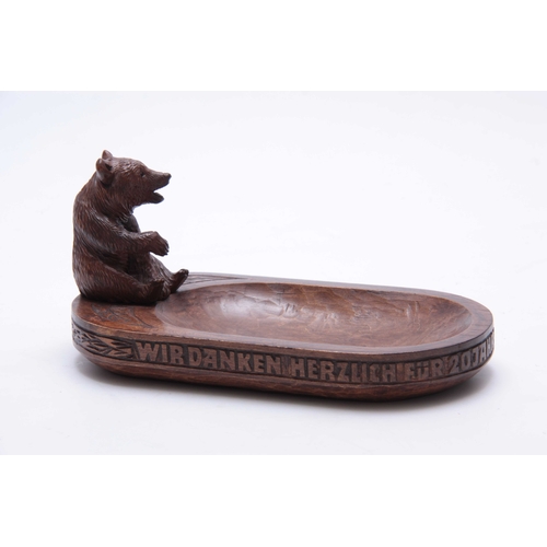 391 - A LATE 19TH CENTURY SWISS BLACK FOREST BEAR DESK TIDY with a seated bear on an oval dished base with... 