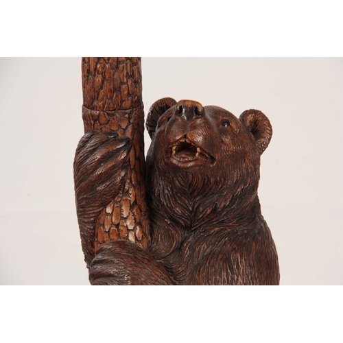 393 - A LATE 19TH CENTURY SWISS CARVED BLACK FOREST BEAR STICK STAND with a large bear with glass eyes hol... 