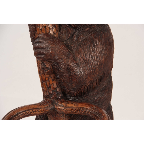 393 - A LATE 19TH CENTURY SWISS CARVED BLACK FOREST BEAR STICK STAND with a large bear with glass eyes hol... 