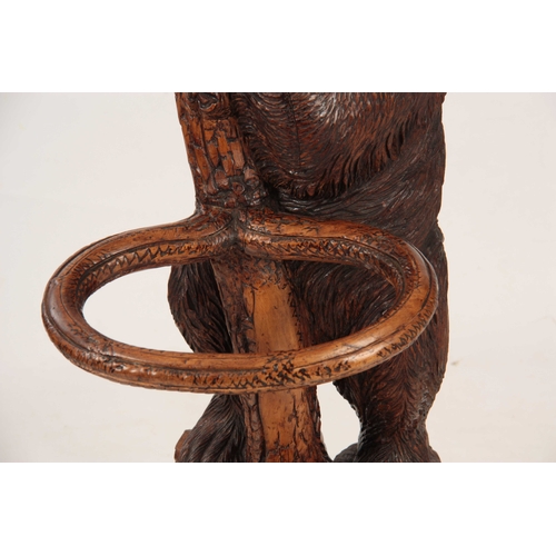 393 - A LATE 19TH CENTURY SWISS CARVED BLACK FOREST BEAR STICK STAND with a large bear with glass eyes hol... 