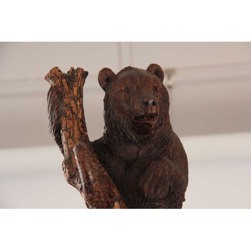 393 - A LATE 19TH CENTURY SWISS CARVED BLACK FOREST BEAR STICK STAND with a large bear with glass eyes hol... 