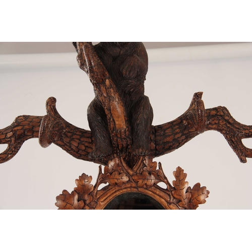 393 - A LATE 19TH CENTURY SWISS CARVED BLACK FOREST BEAR STICK STAND with a large bear with glass eyes hol... 