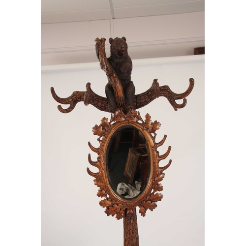 393 - A LATE 19TH CENTURY SWISS CARVED BLACK FOREST BEAR STICK STAND with a large bear with glass eyes hol... 