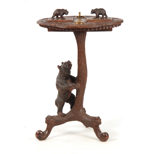 394 - A LATE 19TH CENTURY SWISS CARVED BLACK FOREST SMOKERS TABLE with leaf carved top having two bear lid... 