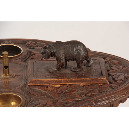 394 - A LATE 19TH CENTURY SWISS CARVED BLACK FOREST SMOKERS TABLE with leaf carved top having two bear lid... 